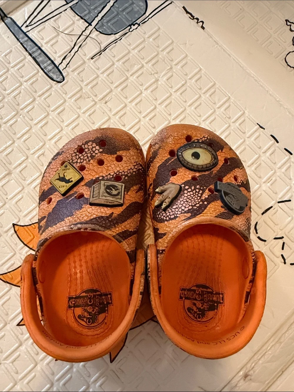 CROCS Kids Orange Patterned Clogs with Character Charms